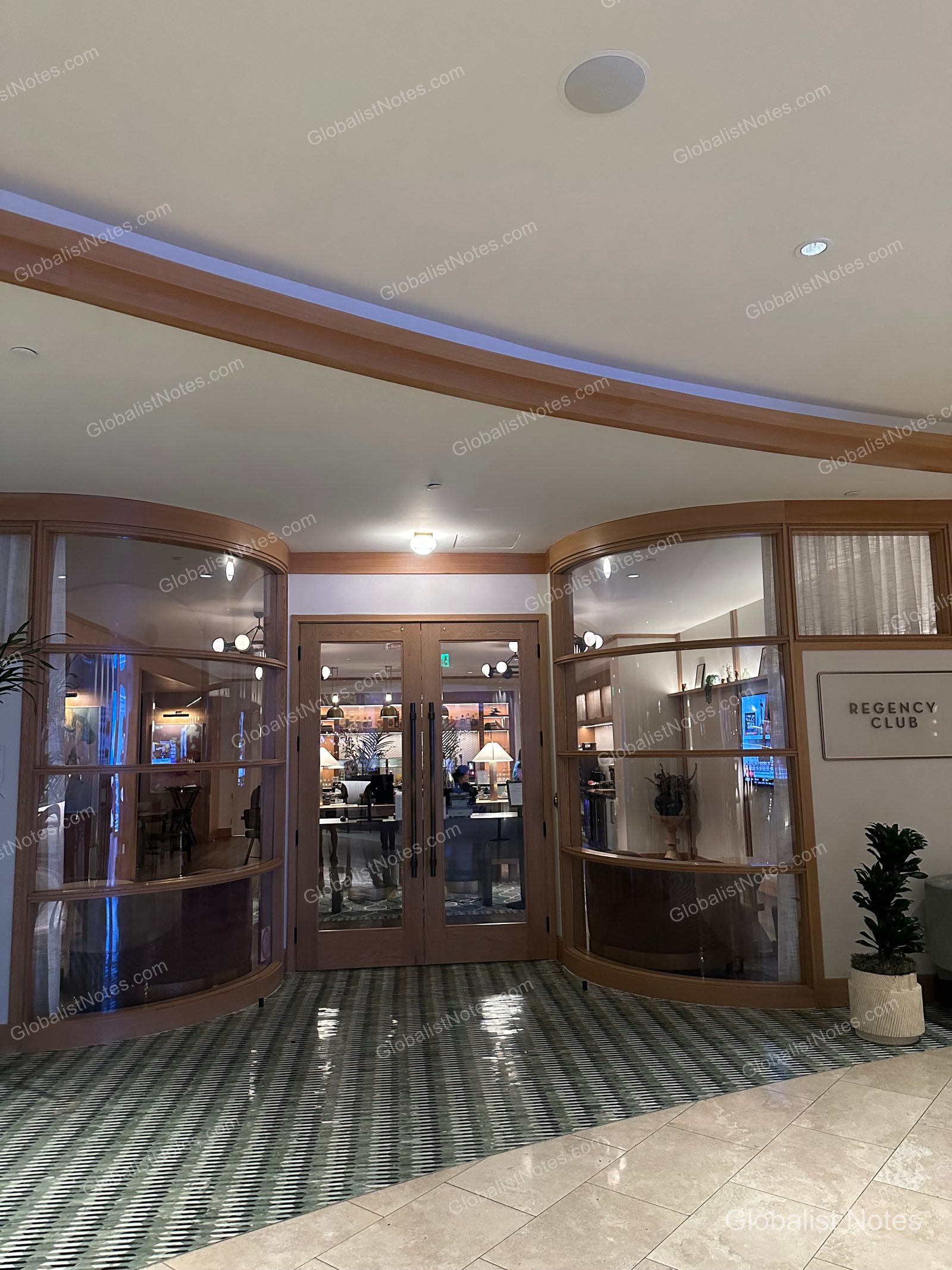 Hyatt Regency Irvine 的 Regency Club 入口，中央為木質邊框的雙開玻璃門，右側牆面掛有 Regency Club 標示，地面鋪設幾何圖案地磚。