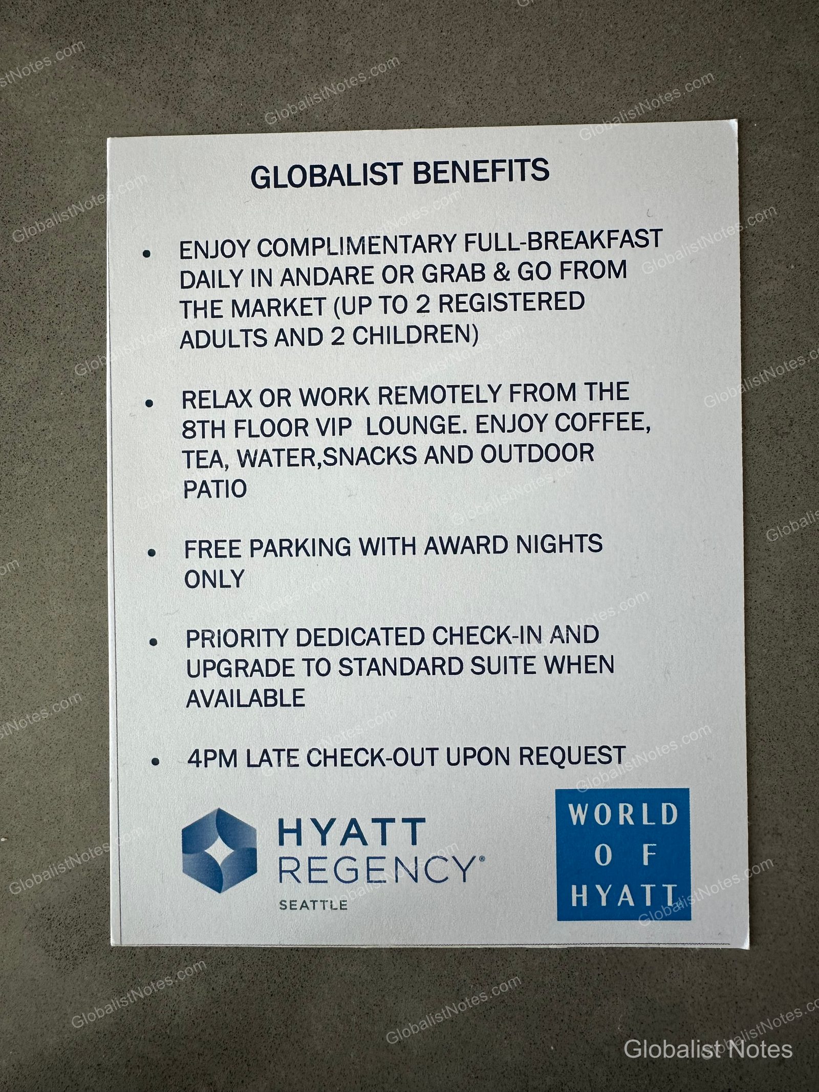 A Globalist benefit guide at Hyatt Regency Seattle. The document lists key benefits in English, including breakfast, access to the 8th-floor VIP lounge, complimentary parking on award stays, room upgrades, and a 4:00 PM late checkout, with the Hyatt Regency logo printed at the bottom.
