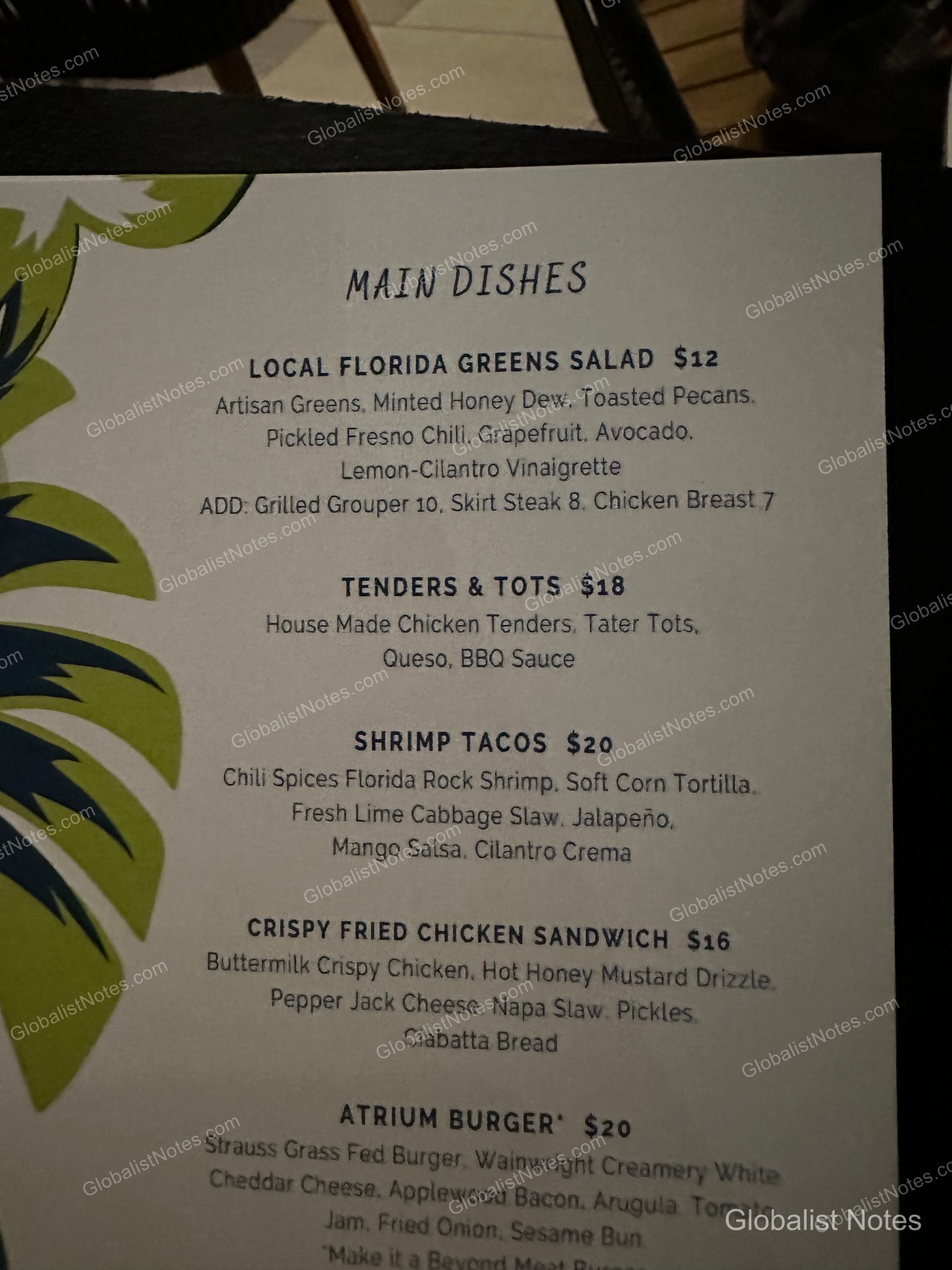 Main dish menu at Hyatt Regency Grand Cypress. The menu lists various items and prices, including the Local Florida Green Salad, Tenders & Tots, Shrimp Tacos, Crispy Fried Chicken Sandwich, and the Atrium Burger.