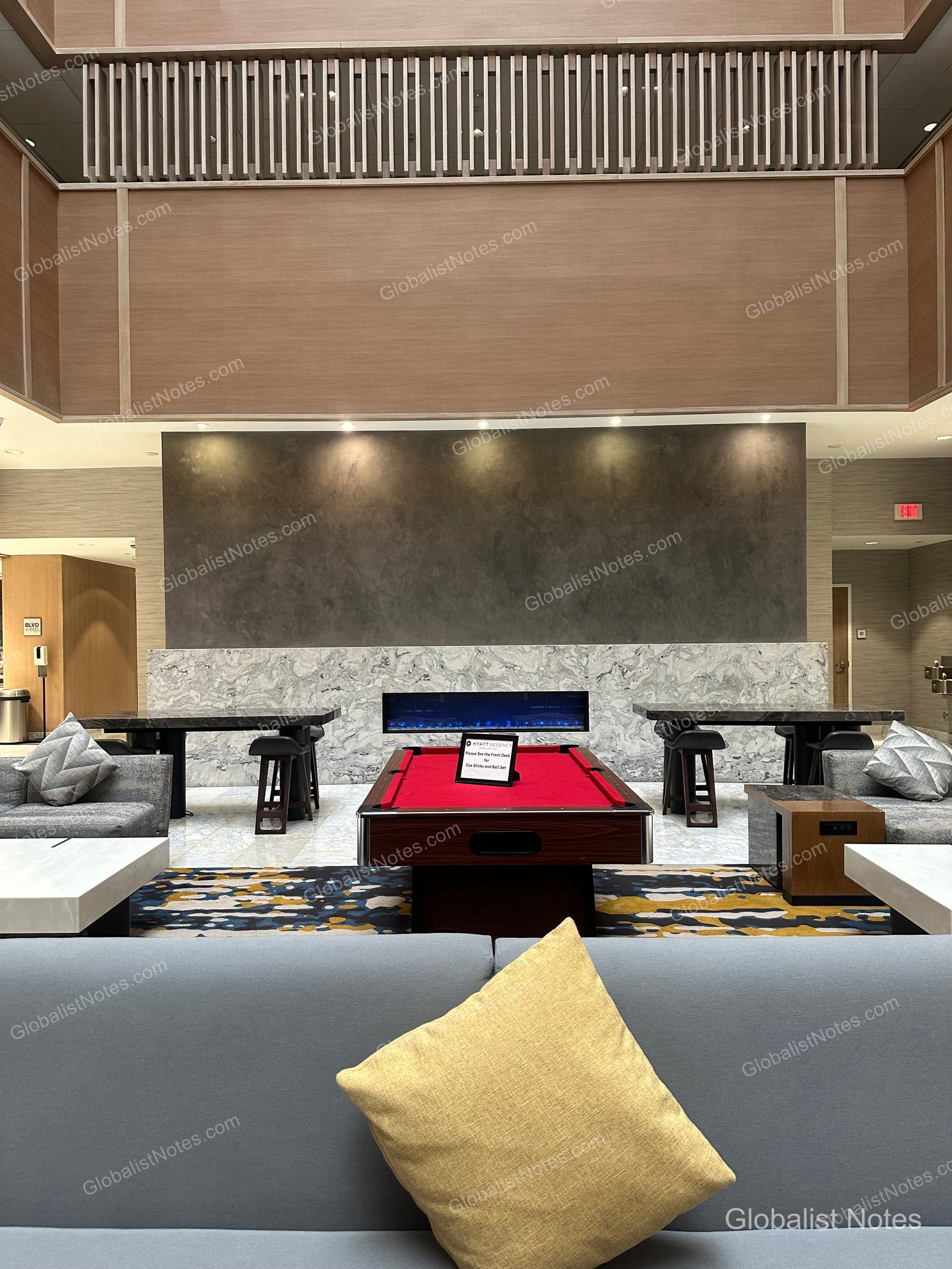 Hyatt Regency Newport Beach 大廳休息區，中央設有紅色撞球桌與壁爐，周圍配置灰色沙發與茶几。